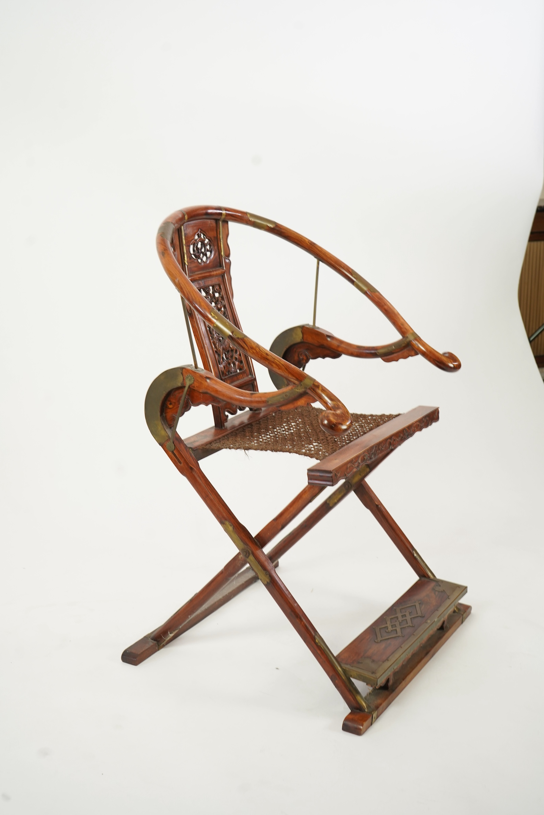 A Chinese huanghuali, hongmu and brass mounted folding hunting chair, jiaoyi, early 20th century